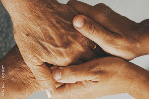 Caring elderly grandma wife holding hand supporting senior grandpa husband give empathy care love, old married grandparents couple together two man and woman hope understanding concept, close up view photo