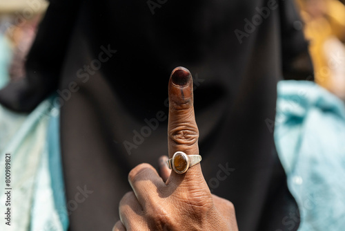 Voter shows inked finger after cast vote photo