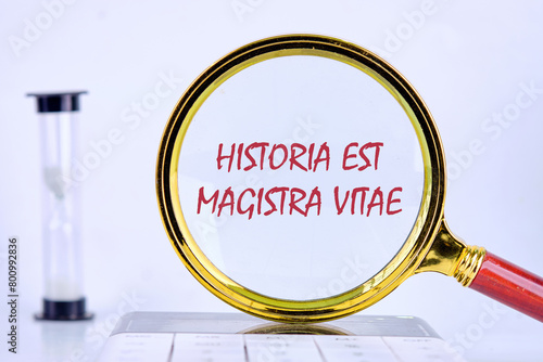 Historia est vitae magistra (History is the tutor of life) Latin phrase, inscription was found with a magnifying glass photo