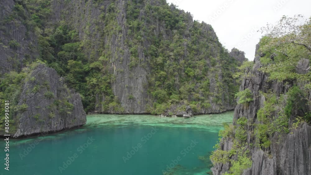 Aerial view of the amazing Big Lagoon in El Nido, Palawan, Philippines. Shallow lagoon with blue water amid jagged Karst Rock cliffs and lush tropical jungle Aerial view of the amazing Big Lagoon in El Nido, Palawan, Philippines. Shallow lagoon with blue water amid jagged Karst Rock cliffs and lush tropical jungle