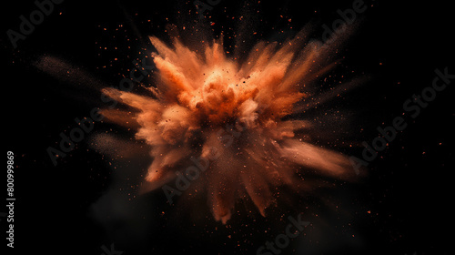 Explosion of powdered orange paint on black background. Graphic materials for Holi Festival or Color Runs.