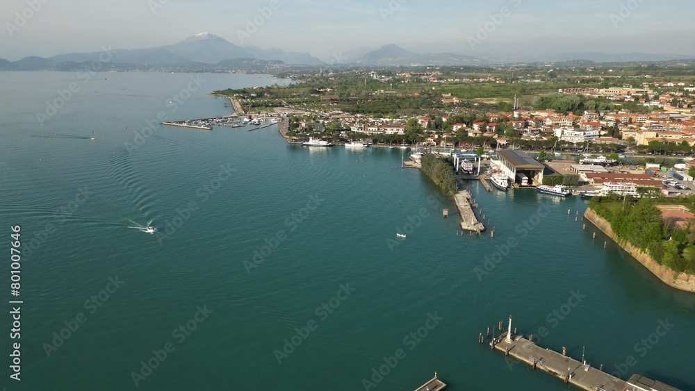 Beautiful panoramic aerial view of Lake Garda. High top view of water landscape with hills of mountains. Peschiera del Garda