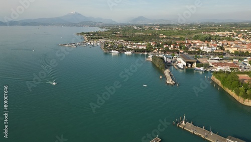 Beautiful panoramic aerial view of Lake Garda. High top view of water landscape with hills of mountains. Peschiera del Garda © Andrew
