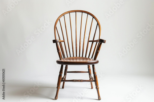 Simple and elegant Windsor chair with a white background.