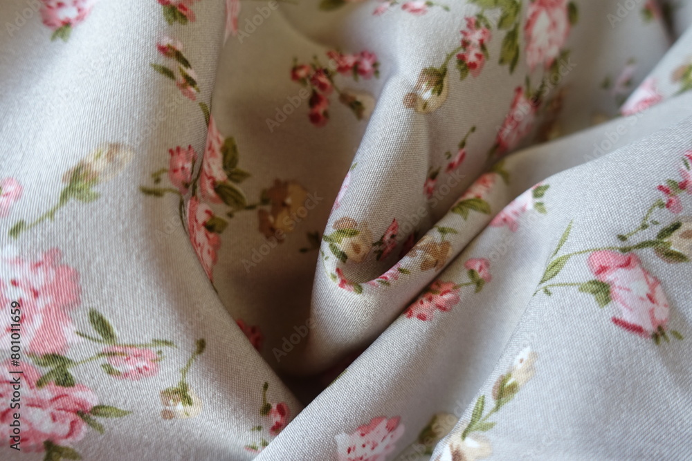 Light grey rayon fabric with old-fashioned floral print in soft folds Light grey rayon fabric with old-fashioned floral print in soft folds