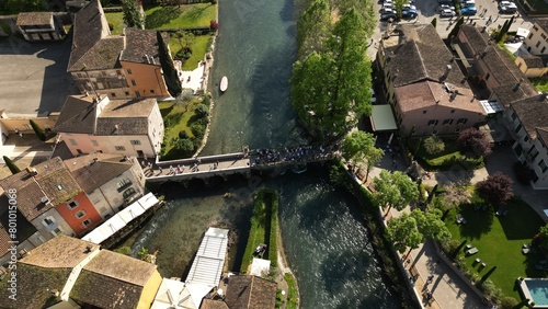 Top view of the mill village of Borghetto sul Mincio in the south of Lake Garda, in Veneto, Italy. Drone footage of the small medieval village. photo