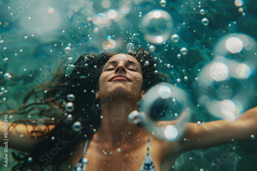 Underwater shot of a woman smiling surrounded by bubbles
