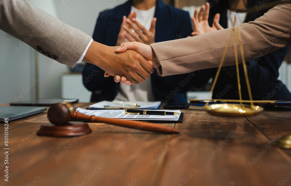 Middle age partner lawyers attorneys shaking hands after discussing a contract agreement done. Middle age partner lawyers attorneys shaking hands after discussing a contract agreement done.