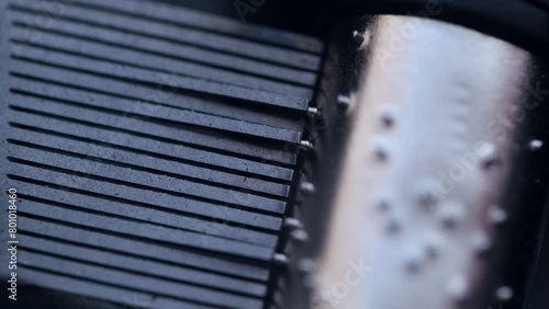 Spinning cylinder of the music box in closeup. Musical mechanism. photo