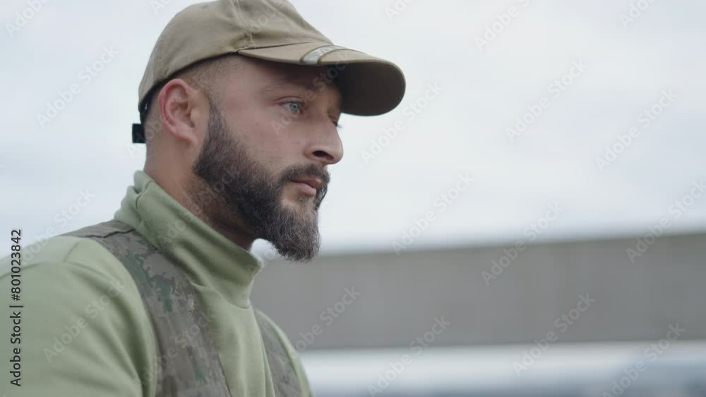 A blue eyed hunter observes something in the bush A blue eyed hunter observes something in the bush