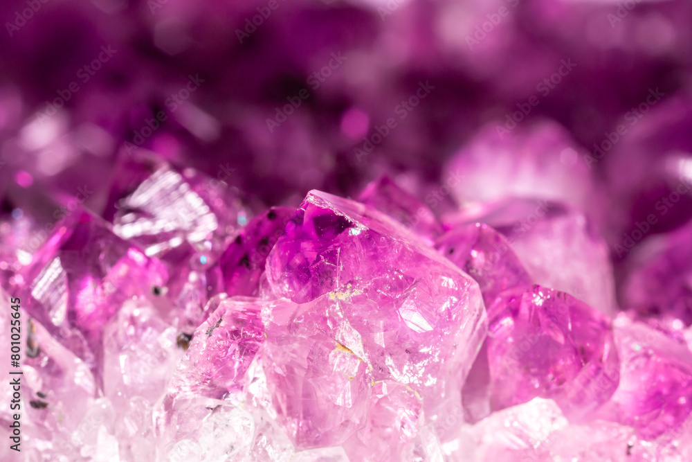 Amethyst pink crystals. Gems. Mineral crystals in the natural environment. Texture of precious and semiprecious stones. Seamless background with copy space colored shiny surface of precious stones. Amethyst pink crystals. Gems. Mineral crystals in the natural environment. Texture of precious and semiprecious stones. Seamless background with copy space colored shiny surface of precious stones.