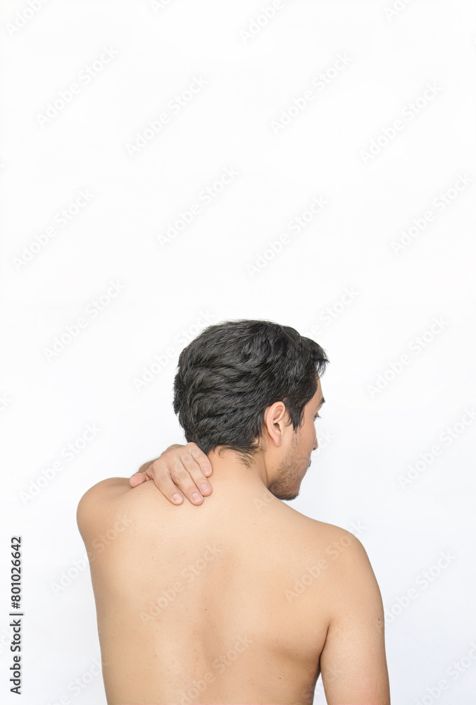 Shirtless man with neck pain showing back with white background and space for text above.