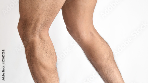 Muscular legs of a man, calves of both feet seen from the side, with a white background and space for text