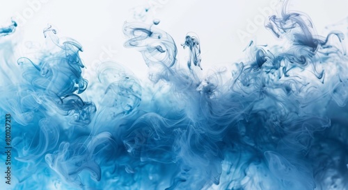 A dynamic swirl of blue smoke on a white background, creating a fluid and ethereal motion effect photo
