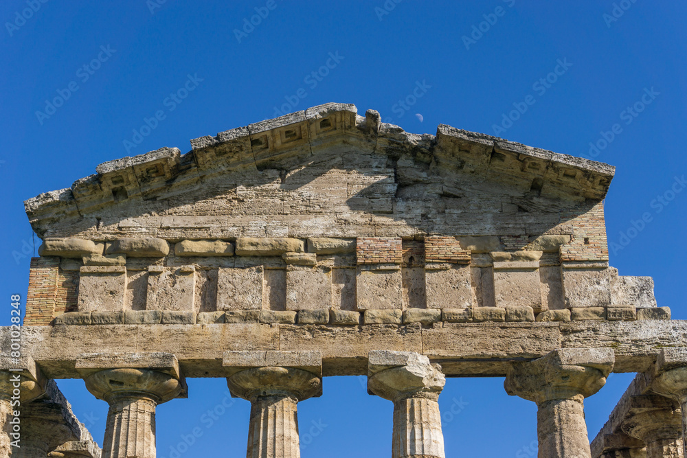 Fototapeta premium Moon over temple of Athena also known as Temple of Ceres at famous Paestum Archaeological UNESCO World Heritage Site, Salerno, Campania, Italy