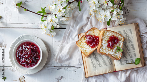 Opened book plate with sweet jam toast and flowers  photo