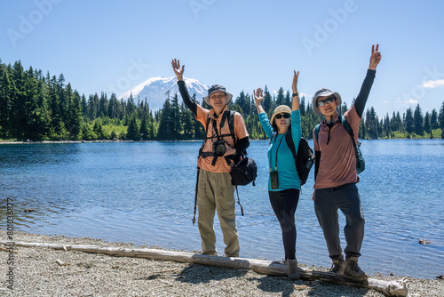 Tourists posing for photos by Summit Lake. Mount Rainier in the background. Mount Rainier National Park. Washington State.