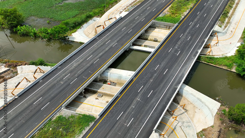Aerial drone view : An awe-inspiring intercity motorway, devoid of traffic, emerges in all its glory. The drone's eye view reveals its grandeur, a testament to engineering excellence. Road background. Aerial drone view : An awe-inspiring intercity motorway, devoid of traffic, emerges in all its glory. The drone's eye view reveals its grandeur, a testament to engineering excellence. Road background.