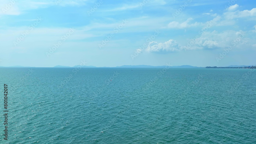 Fototapeta premium A breathtaking vista unfolds as the drone's eye captures the deep blue sea beneath the vast, cloud-kissed sky. Incredible natural beauty: Awe-inspiring sights abound. Nature concept. 