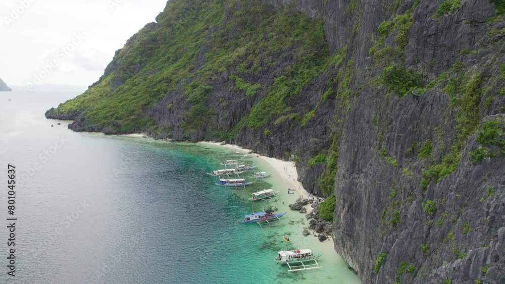 Aerial view of the amazing Big Lagoon in El Nido, Palawan, Philippines. Shallow lagoon with blue water amid jagged Karst Rock cliffs and lush tropical jungle Aerial view of the amazing Big Lagoon in El Nido, Palawan, Philippines. Shallow lagoon with blue water amid jagged Karst Rock cliffs and lush tropical jungle