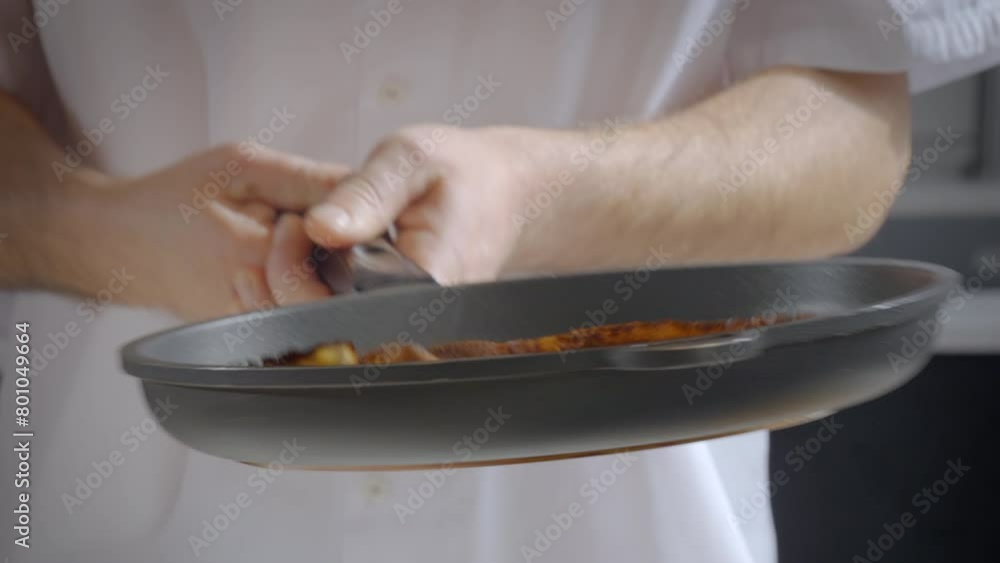 Slow-motion of a man's hands flipping pancakes, french crepes in the air from a pan. Slow-motion of a man's hands flipping pancakes, french crepes in the air from a pan.