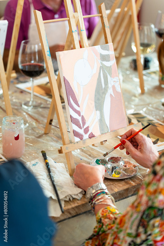 Painting and sip workshop. Woman enjoying art and wine.