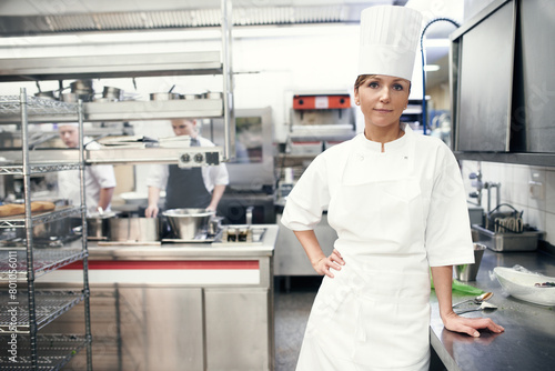 Woman, portrait and chef in professional kitchen for cooking fine dining in hat or uniform, hospitality or service. Female person, face and restaurant employee or menu preparation, nutrition or food