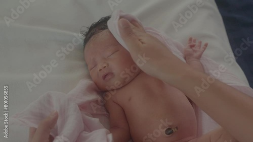 Close up mother hand is drying her child after bathing.