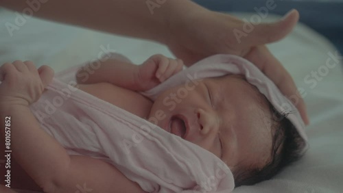 Closeup mother hand wiping dry her child after bathing