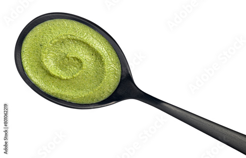 Spoon of broccoli cream soup isolated on white background. Top view