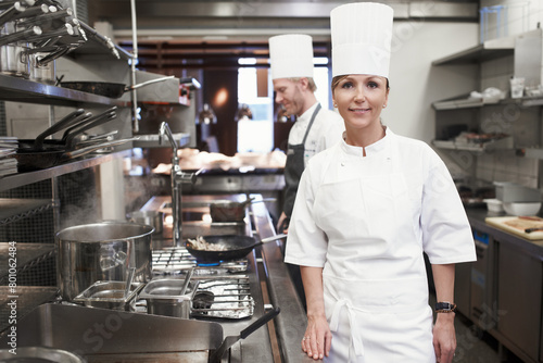 Smile, chef and portrait of woman in kitchen for hospitality service, career and cuisine at restaurant. Fine dining, happy and face of cook in food industry for catering, culinary and job in Italy