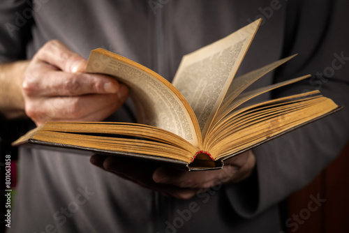 Men opening and reading a old book, close up