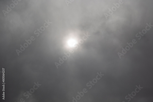 Cloudy sky with sun and sunbeams. Nature background.
