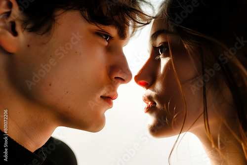 A young man and woman opposite look languidly at each other through sunglasses. On a white background. photo