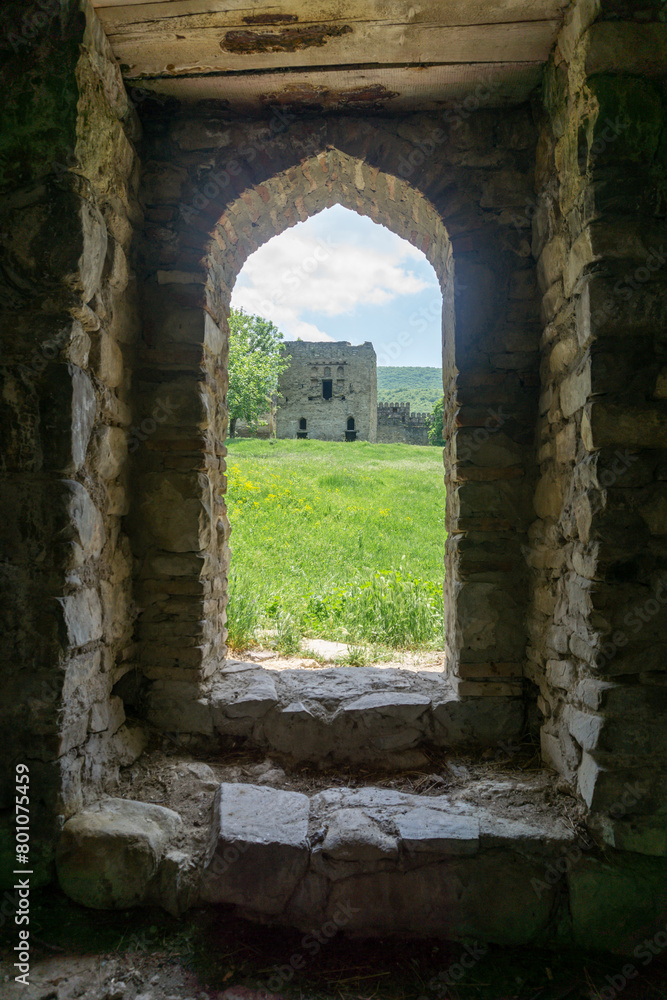 Tower in the courtyard of Nichbisi fortress, Georgia. View from arch pass of the bath. Tower in the courtyard of Nichbisi fortress, Georgia. View from arch pass of the bath.