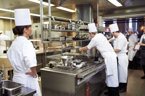 Chef, staff and cooking professional in kitchen for evaluation of culinary education, training and performance management. Woman, students and supervision for feedback or guidance and learning skill.