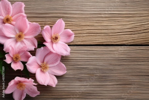 Soft pink flowers elegantly displayed on a wooden background, perfect for a serene and sophisticated floral arrangement theme with space for text on the side.