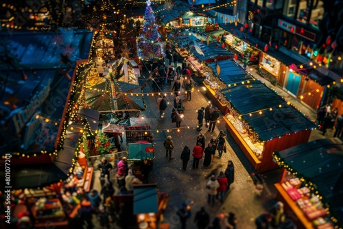 An aerial view showing the vibrant atmosphere of a busy Christmas market at night, with multiple vendors selling various festive items