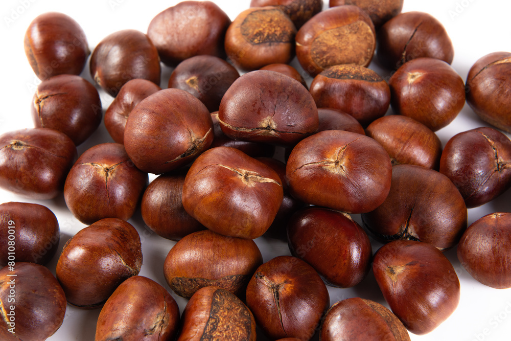 closeup of roasted chestnut on white background. closeup of roasted chestnut on white background.
