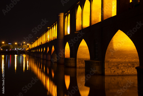 the beautiful view of the city of Isfahan and the zayandeh rud River at night and the thirty-three bridge (siose pol) of this city, which have a special view at night with lighting photo