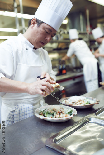 Asian man  chef and plate with food in kitchen for restaurant  service and hospitality in Bangkok. Male cook  gourmet meal and nutrition for fine dining  wellness and catering for hotel in Thailand