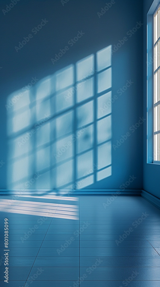 A blue room with a window that is letting in sunlight. The room is empty and has a very clean and simple design A blue room with a window that is letting in sunlight. The room is empty and has a very clean and simple design