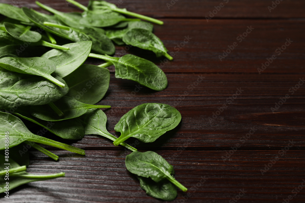 Fresh spinach leaves on wooden table, closeup. Space for text Fresh spinach leaves on wooden table, closeup. Space for text