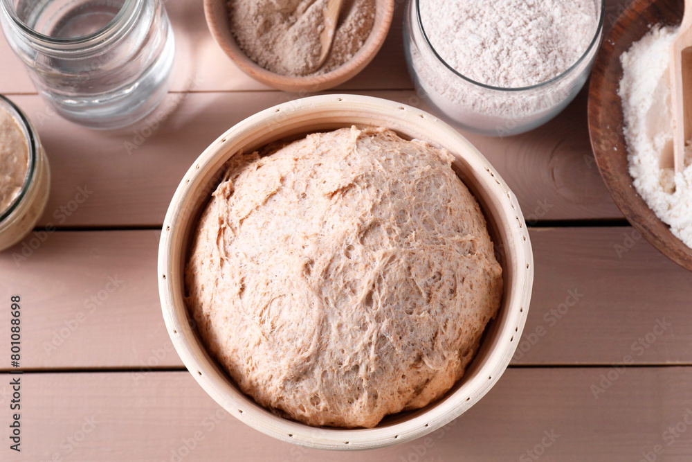 Fresh sourdough, flour and water on wooden table, flat lay Fresh sourdough, flour and water on wooden table, flat lay