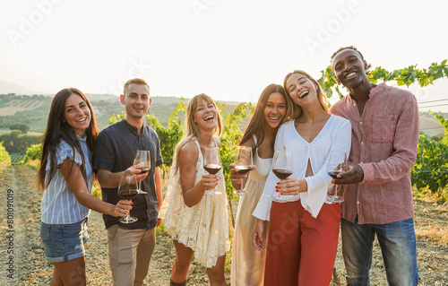 Happy friends cheering with red wine at countryside summer event - Multiracial people having fun during food tour vacation - Travel and traditional products taste concept - Focus on blond girl face
