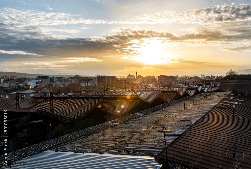 Industrial suburb rooftops and cityscape at a beautiful sunset