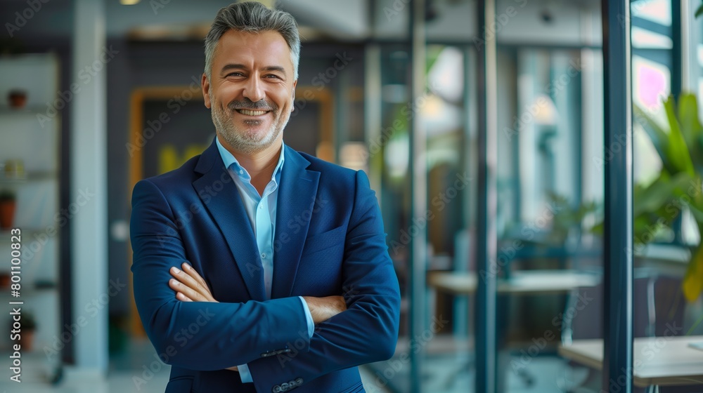 Portrait of a middle-aged businessman man demonstrating confidence and maturity in the business environment in luxurious corporate office. Portrait of a middle-aged businessman man demonstrating confidence and maturity in the business environment in luxurious corporate office.