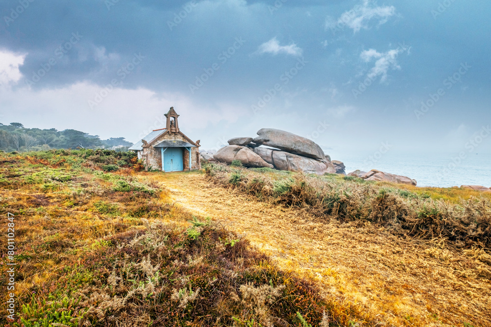 Small church in pink granite coast in Ploumanac'h in Brittany. The Devil's Chapel along the customs road -France