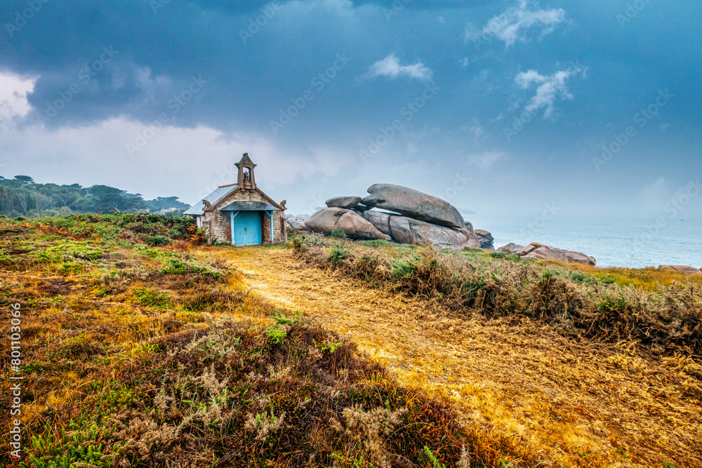 small chapel on the coast of french brittany. Chapel of St. Guirec between rocks, Sentier des Douaniers hiking trail, Ploumanac'h, Côte de Granit Rose, Brittany, France