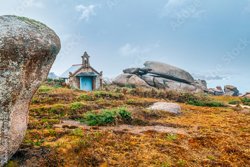 small chapel on the coast of french brittany. The Devil's chapel on the Pink Granite Coast in northern Brittany, France, with its granite chimeras is in fact a boathouse. photo